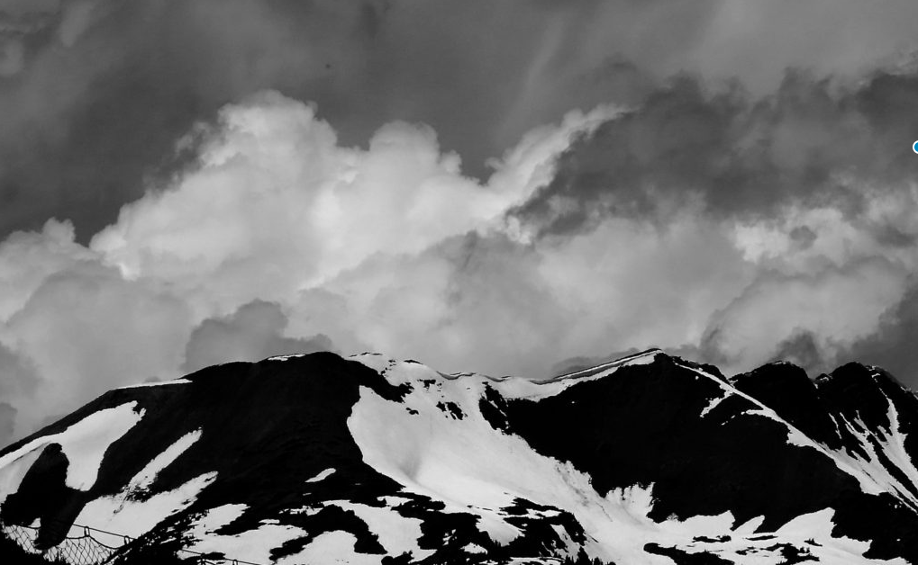 Storm clouds over snowy mountain range display the splendor and majesty of God, Crested Butte, Colorado